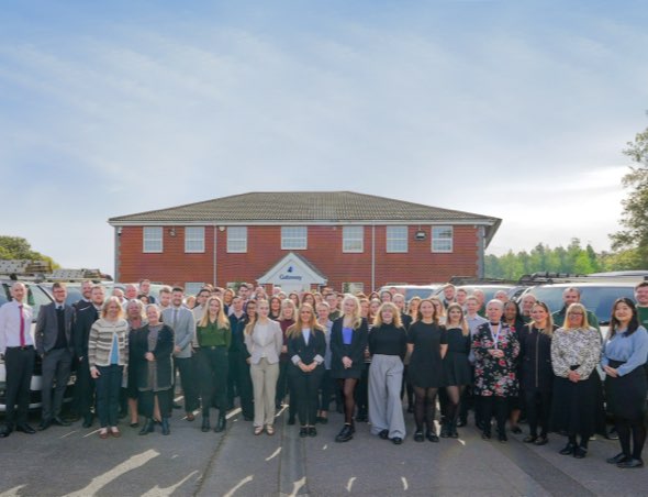 Portrait of Gateway employees standing outside office