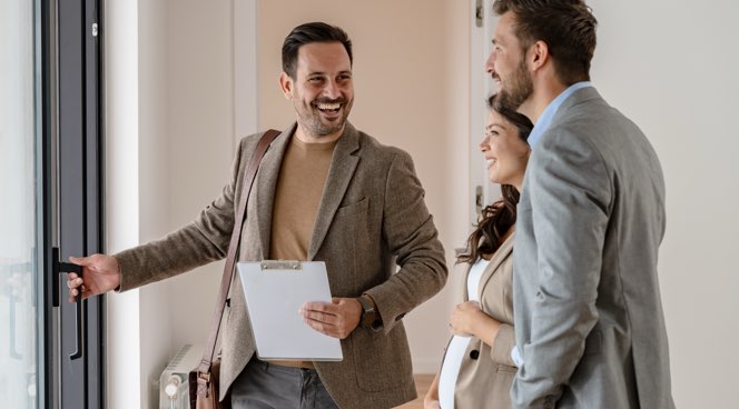 Estate Agent showing couple around property