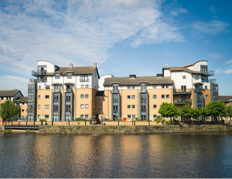 Exterior view of block of flats along riverbank