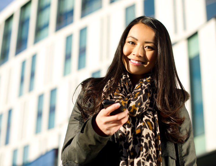 Lady standing outside apartment buildings